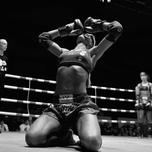A photo of a fighter demonstrating the Wai Kru at an event showcasing some of the best Bangkok Muay Thai gyms in Thailand