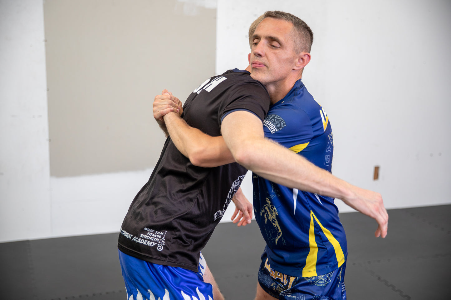 A photo of two Muay Thai fighters demonstrating techniques.