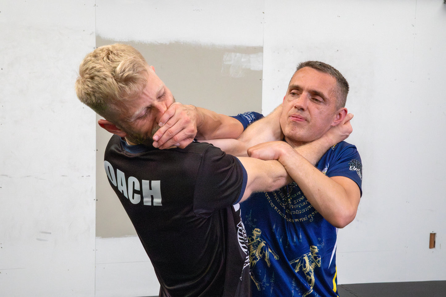A photo of two Muay Thai fighters demonstrating techniques.