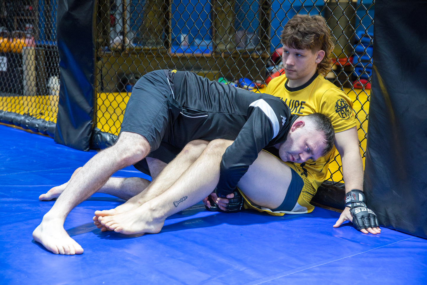 A photo of two MMA fighters training