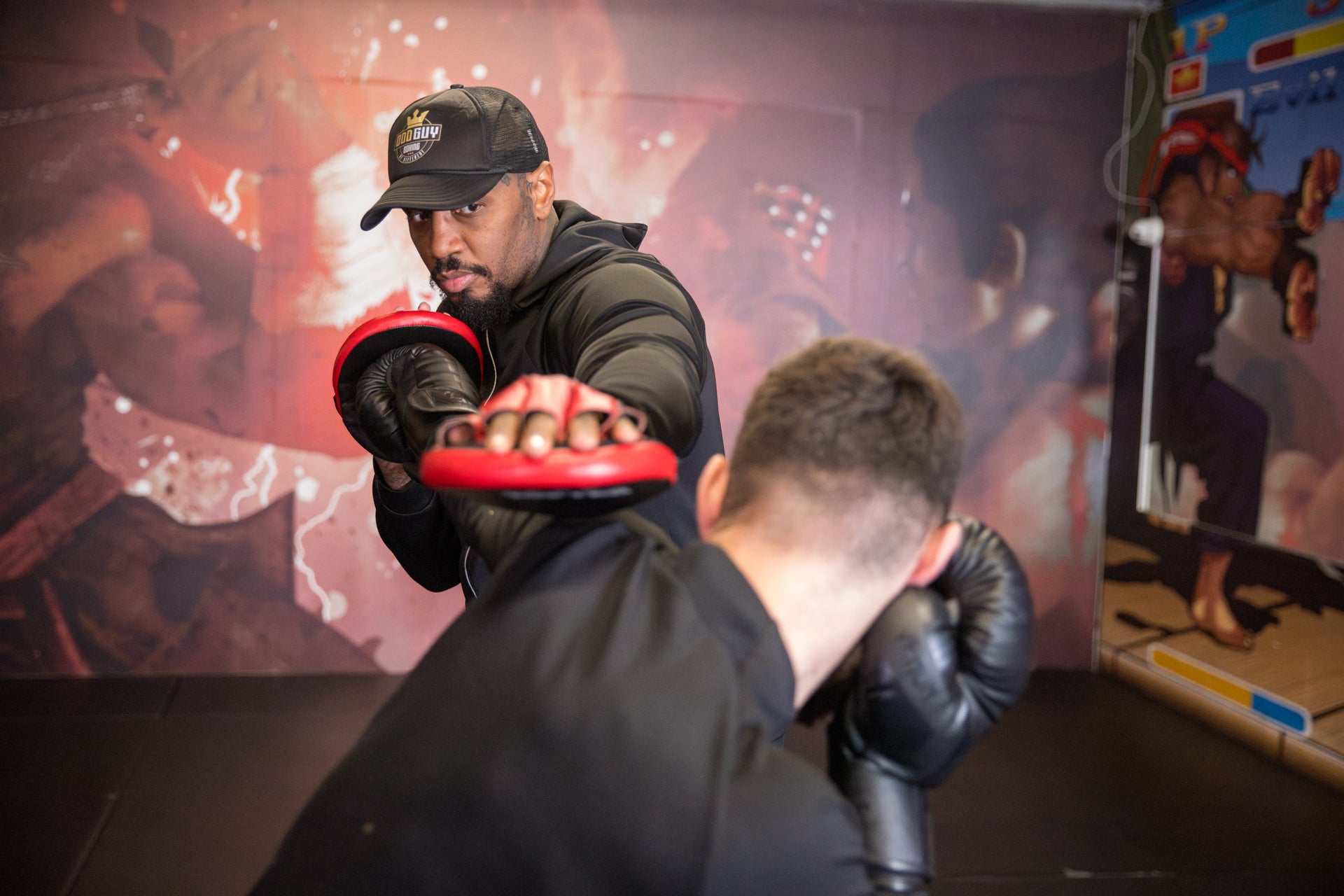 A photo of a boxer demonstrating pad work