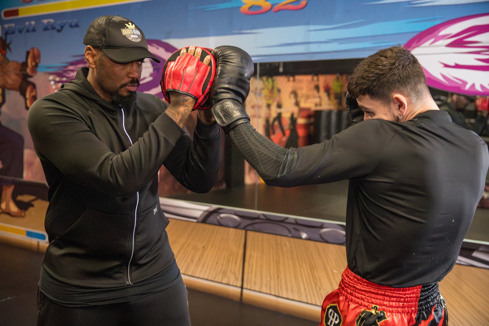 A photo of a boxer demonstrating pad work