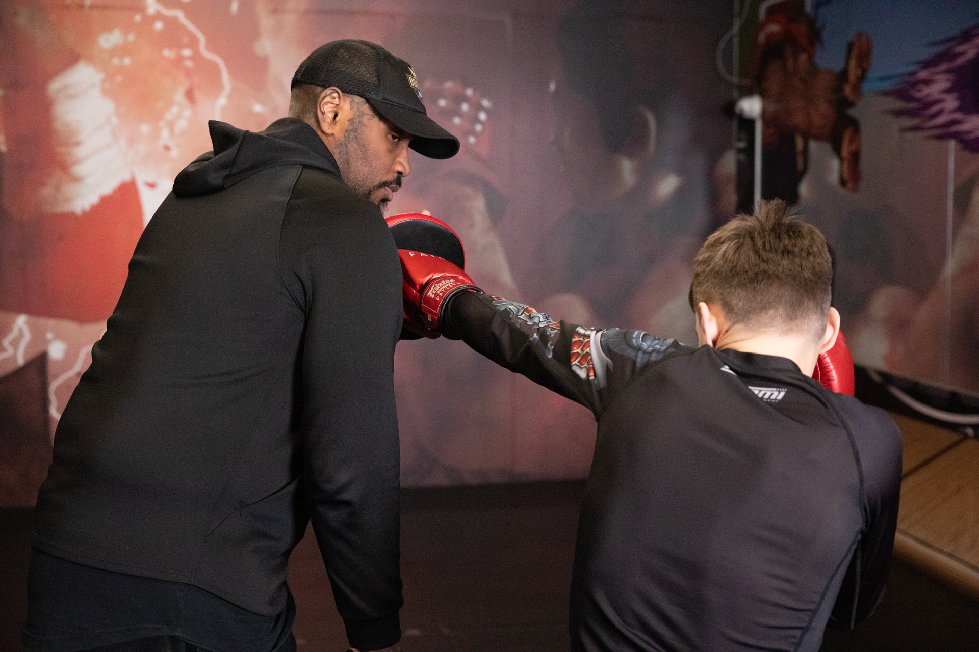A photo of a boxer demonstrating pad work