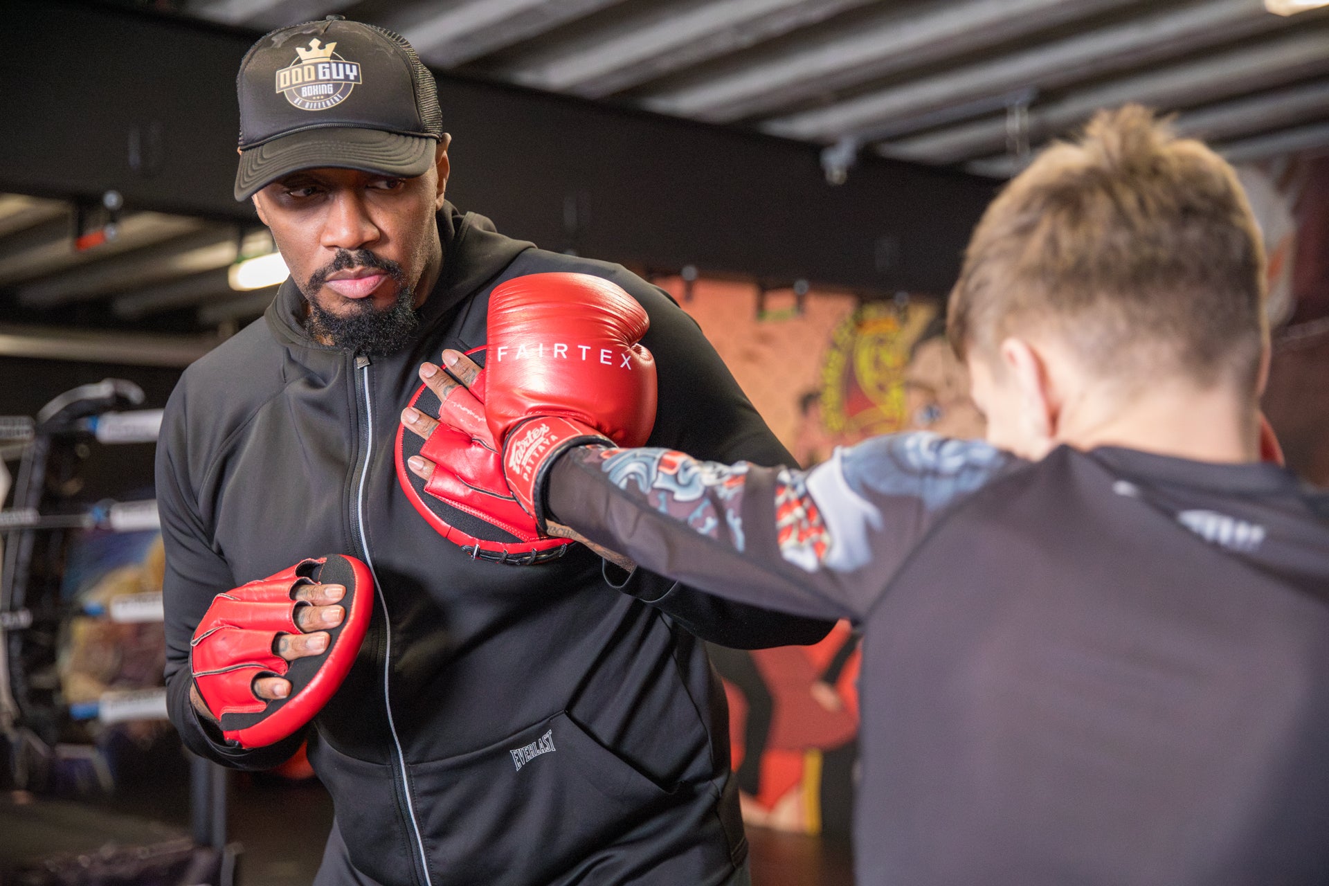 A photo of a boxer demonstrating pad work
