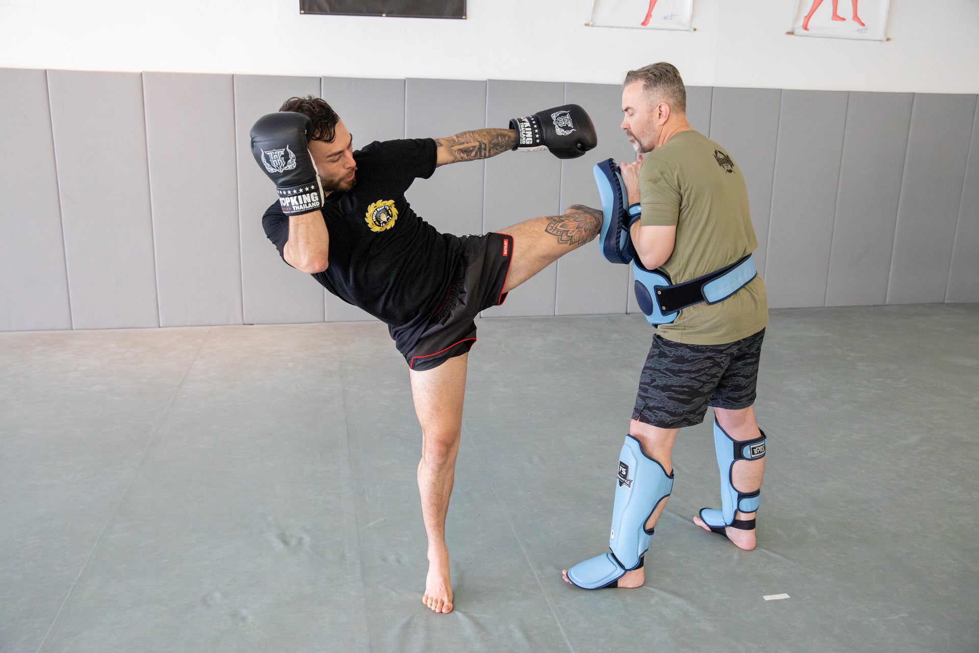 a photo of a coach holding pads for an athlete