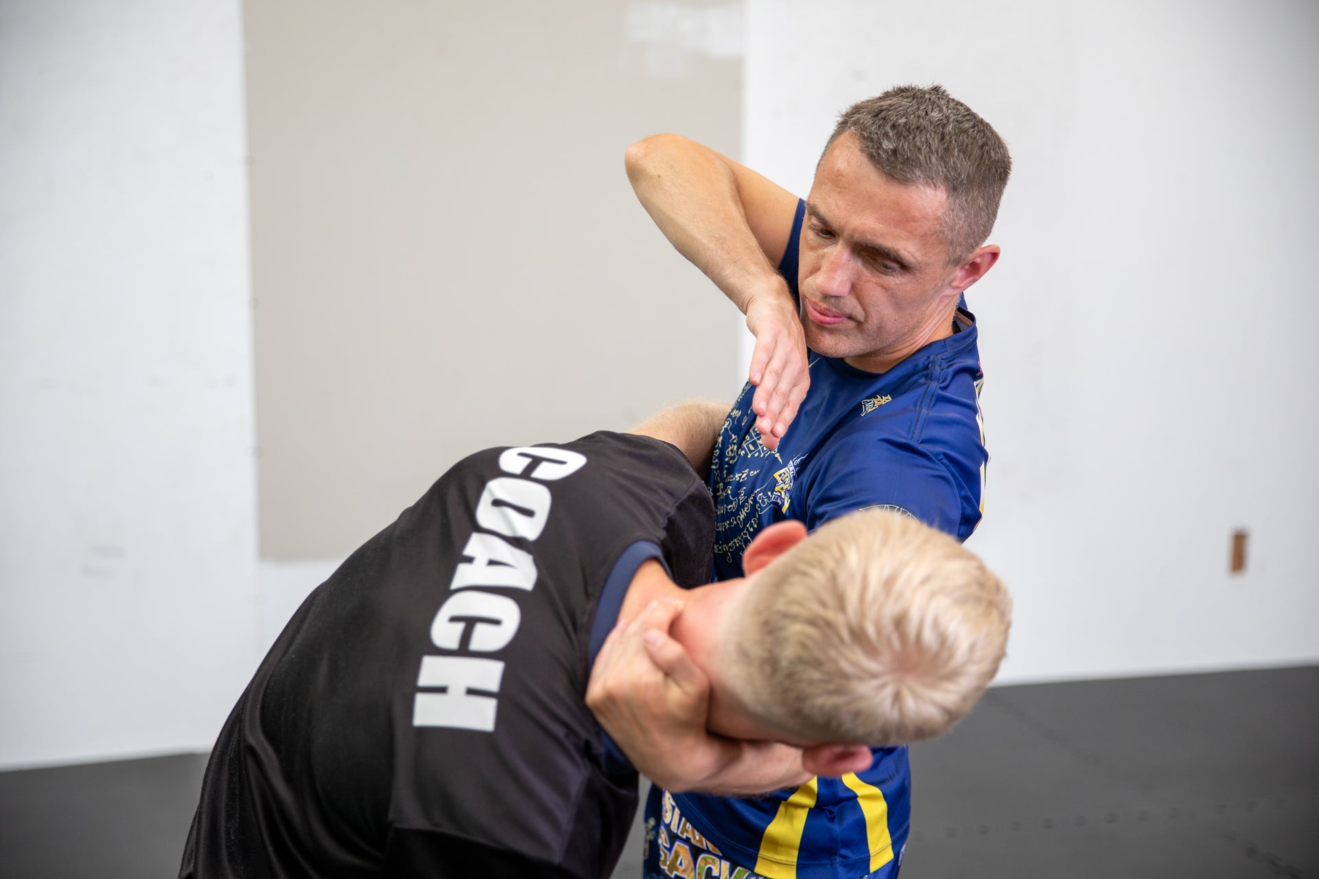A photo of two Muay Thai fighters demonstrating techniques.