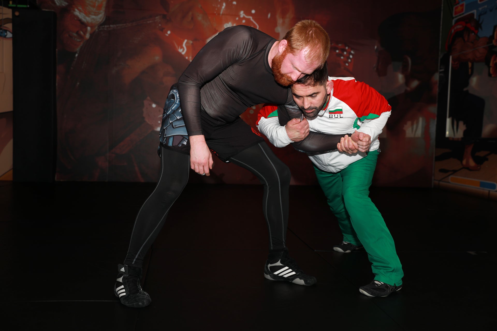 A photo of an athlete demonstrating setting up a takedown
