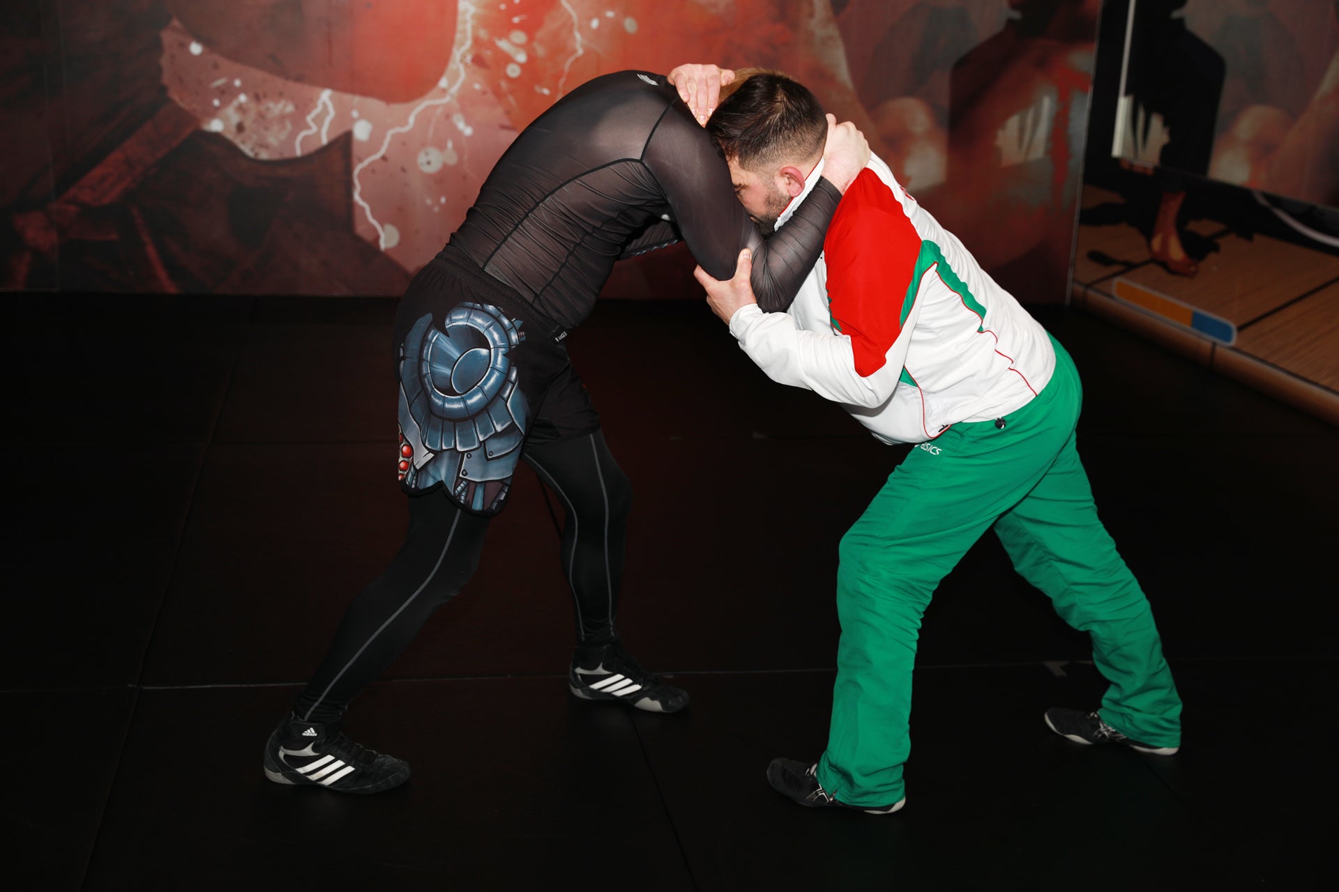 A photo of an athlete demonstrating setting up a takedown