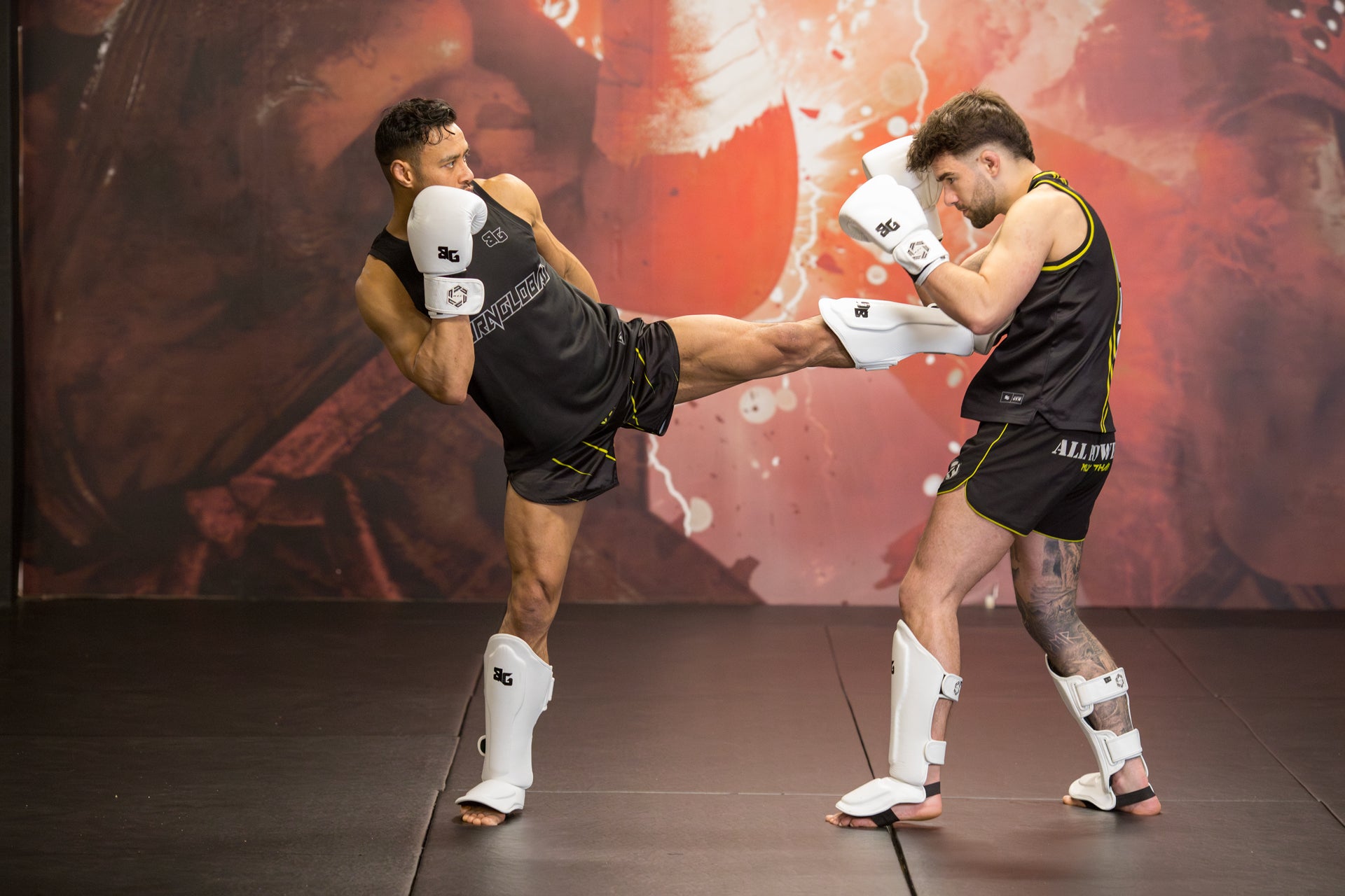 A photo of two fighters demonstrating Muay Thai techniques