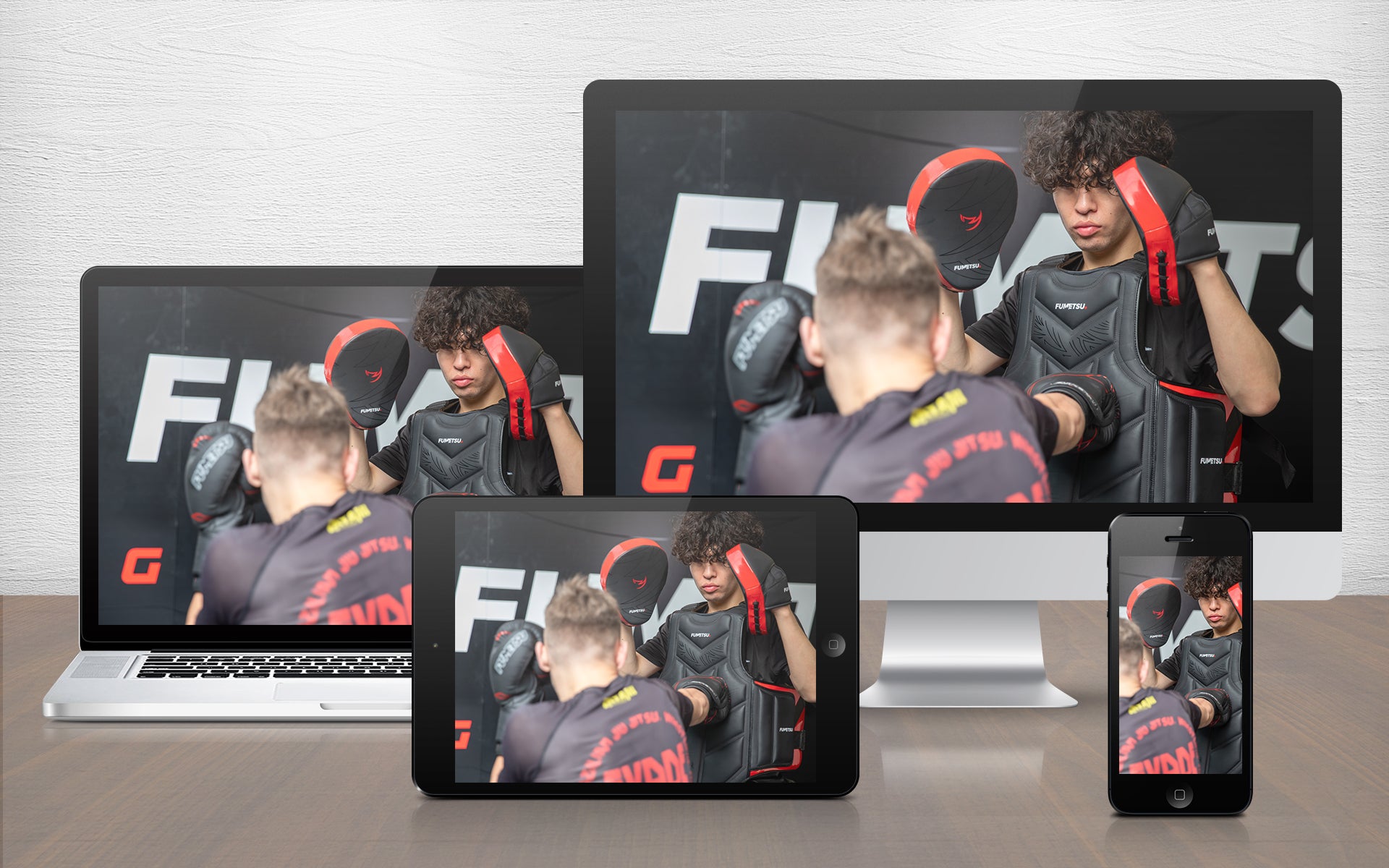 Multiple devices displaying a person in martial arts gear with 'Fumetsu' branding.