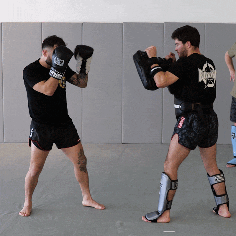 Two fighters training together demonstrating a variety of clinch, knee, elbow and boxing techniques
