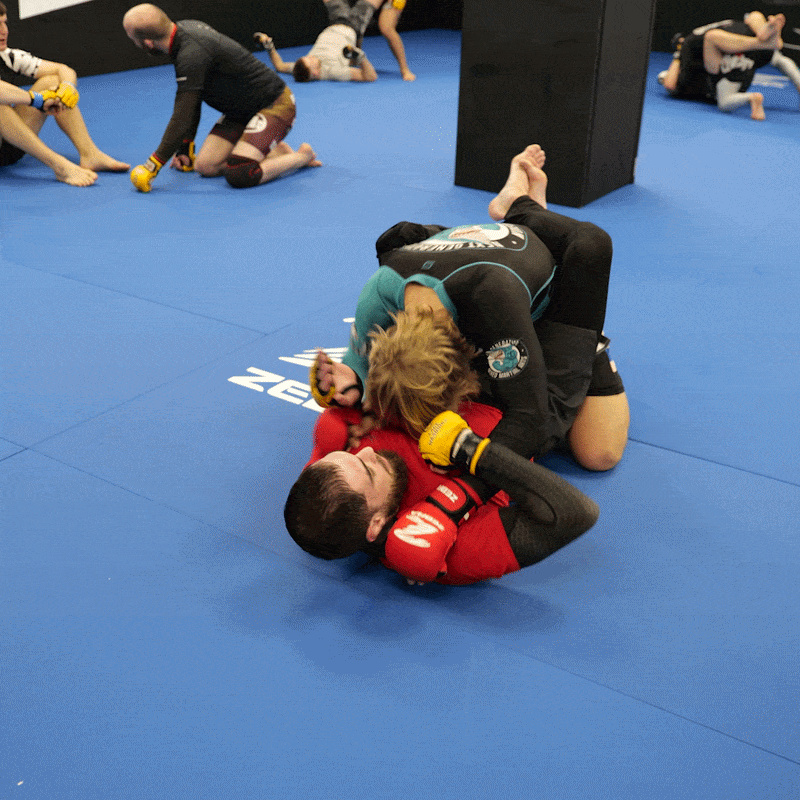 Two fighters training together in MMA in a Martial Arts gym
